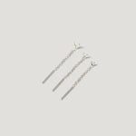 Three silver chain bar earrings with triangle studs on light background