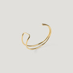 Gold cuff bangle with a double wire band, angular kink visible on the left side.