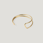 Gold cuff bangle with a double wire band, angular kink visible on the right side.