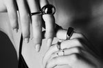 Close-up of hands wearing modern silver rings, minimalist jewellery style