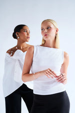 Two women wearing elegant silver jewellery, earrings, rings, and bracelets, minimal background