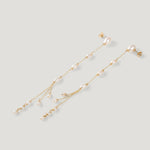 Pair of gold drop earrings with freshwater pearls along chain, clustered tassel ends.
