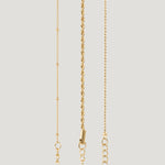 Gold bracelet set with beaded, twisted rope and beaded chain strands on light background.