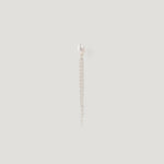 Silver earring with a freshwater pearl stud and dangling chain tassel on light background