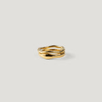 Two organic wavy gold rings stacked together, viewed side-on, one slim and one wide.