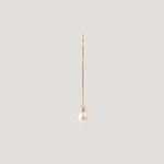 Single gold thread earring with a pearl drop, hanging vertically on light background.