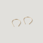 Pair of small gold thread earrings, a rounded arch shape on light background.
