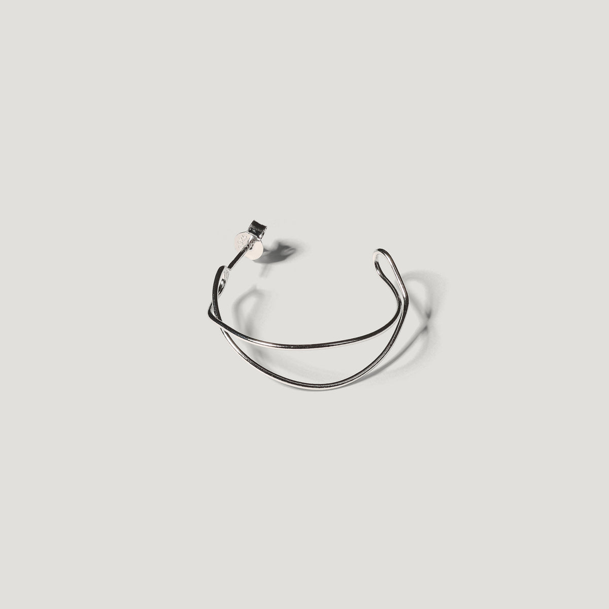 Single silver wire hoop earring viewed front-on, showing its open double-wire shape.