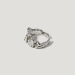 Textured silver ring with organic, sculptural design on white background
