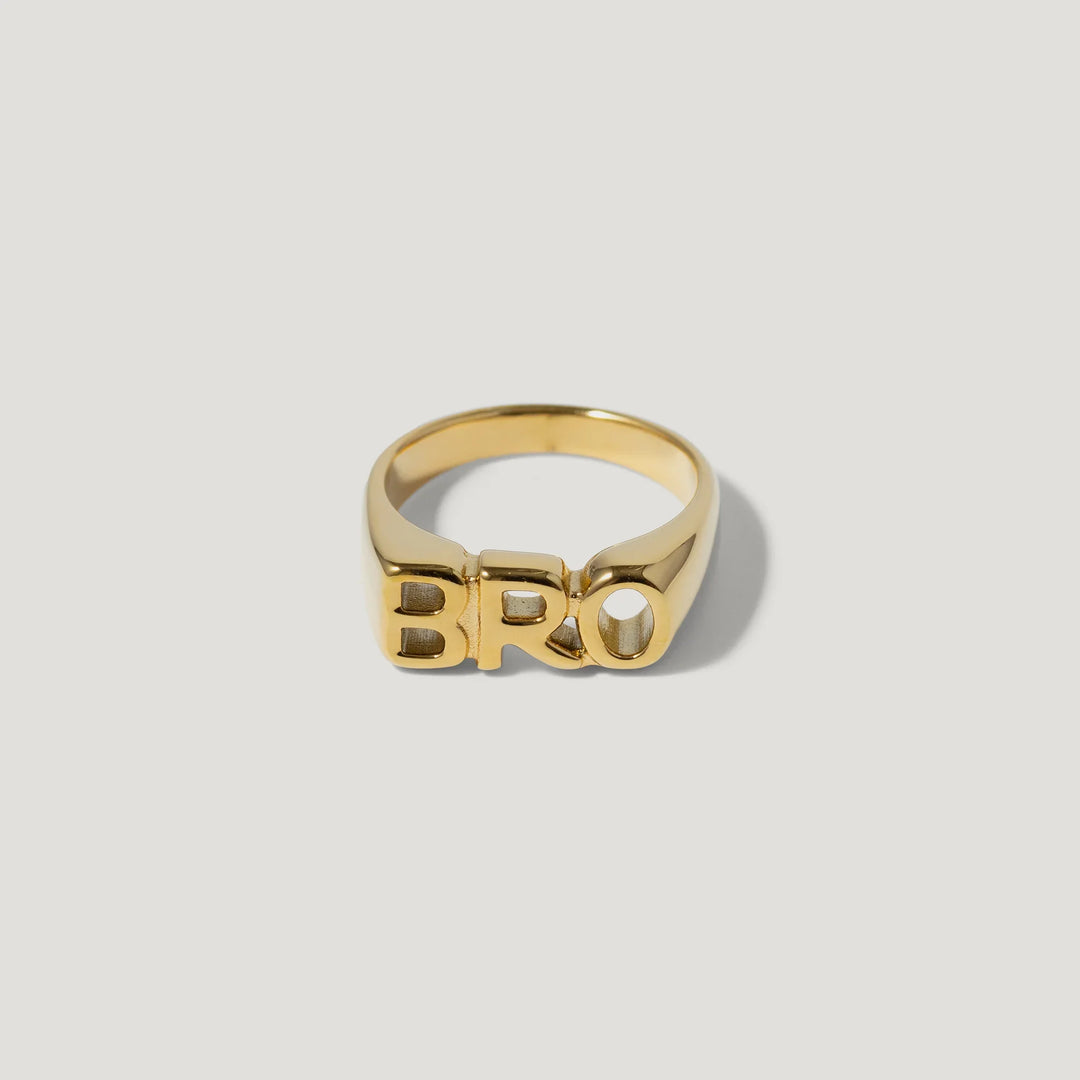 Gold ring with bold 'BRO' lettering on white background, modern jewelry design
