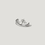 Sterling silver curved stud earring with textured grooves on a light background