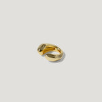 Chunky gold open band ring with a modern, sculptural design on a white background
