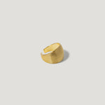 Textured gold adjustable ring with ridged design on a light background
