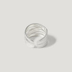 Textured open band silver ring on plain light background, modern minimalist jewelry