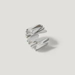 Modern silver ring with sculptural, angular design on a white background