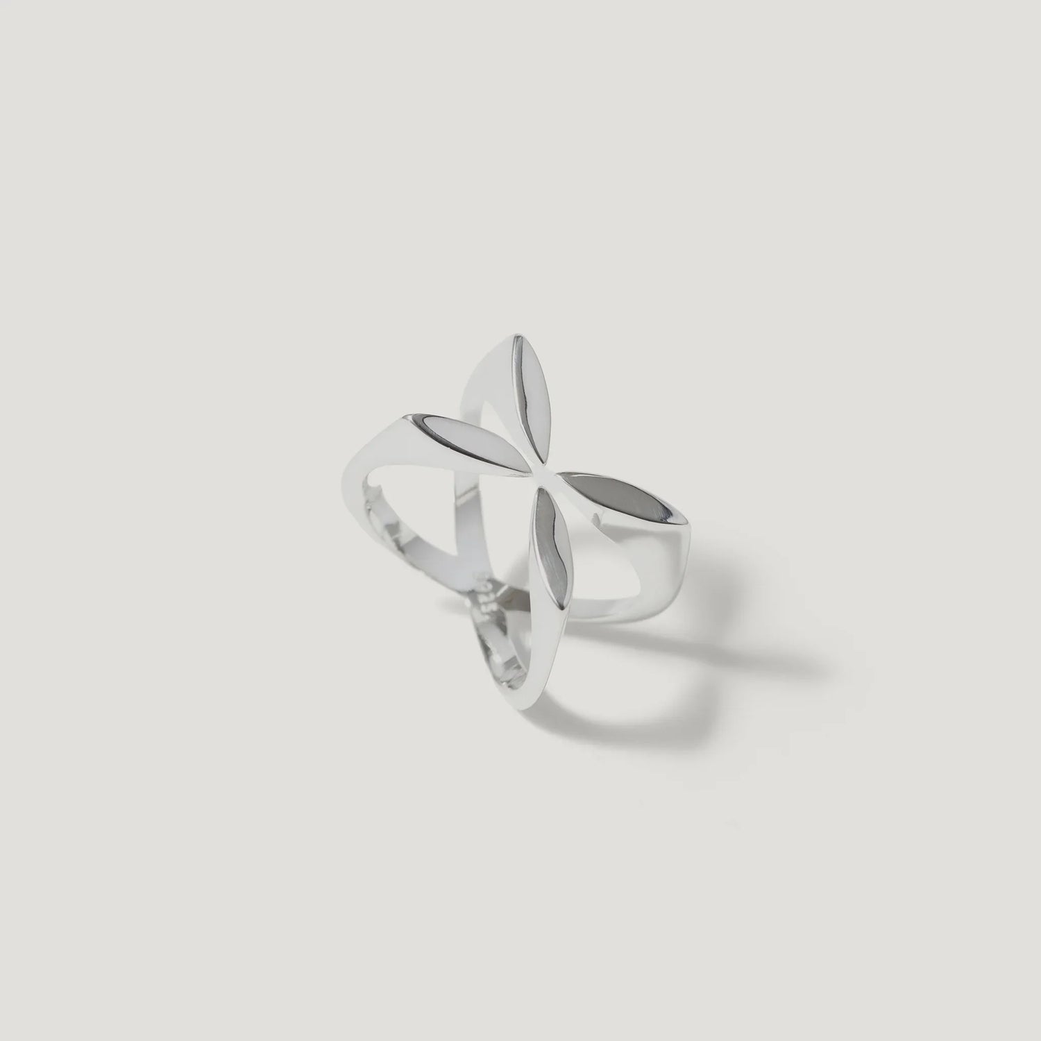 Sterling silver openwork ring with geometric floral design on white background