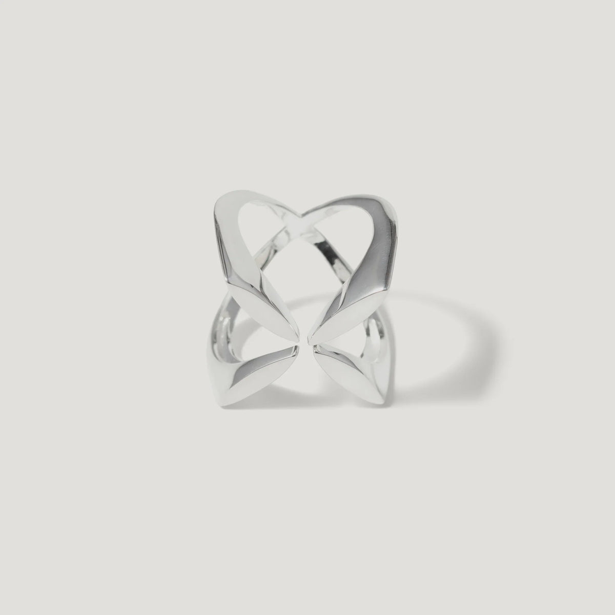 Modern openwork silver ring with abstract geometric design on white background