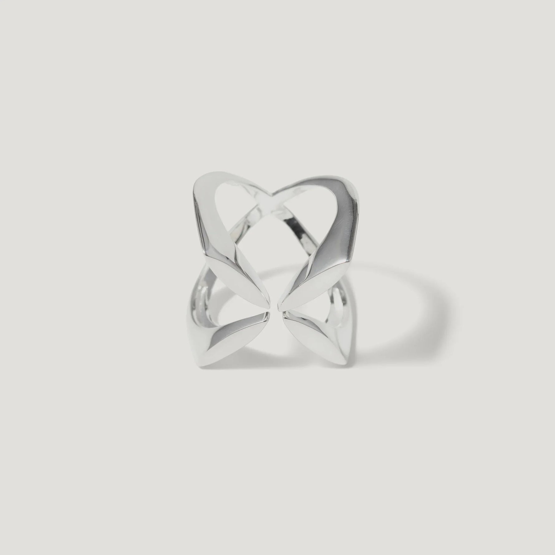 Modern openwork silver ring with abstract geometric design on white background