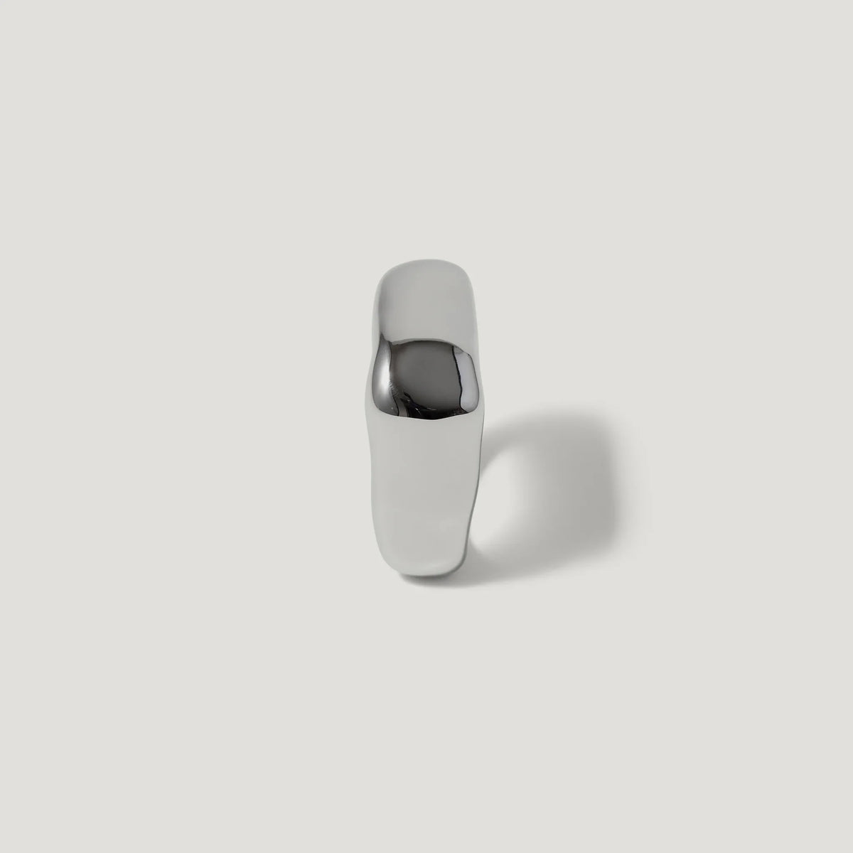Minimalist silver ring with polished, chunky design on white background