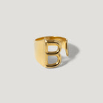 Gold letter B open band ring on plain background