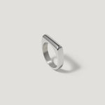 Minimalist silver geometric ring with flat top on white background