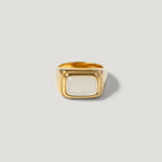 Gold signet ring with a square white stone, minimalist and modern design on plain background