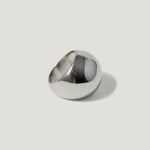 Polished silver dome ring with a modern, minimalist design on a light background