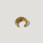Gold textured ear cuff with twisted design on white background
