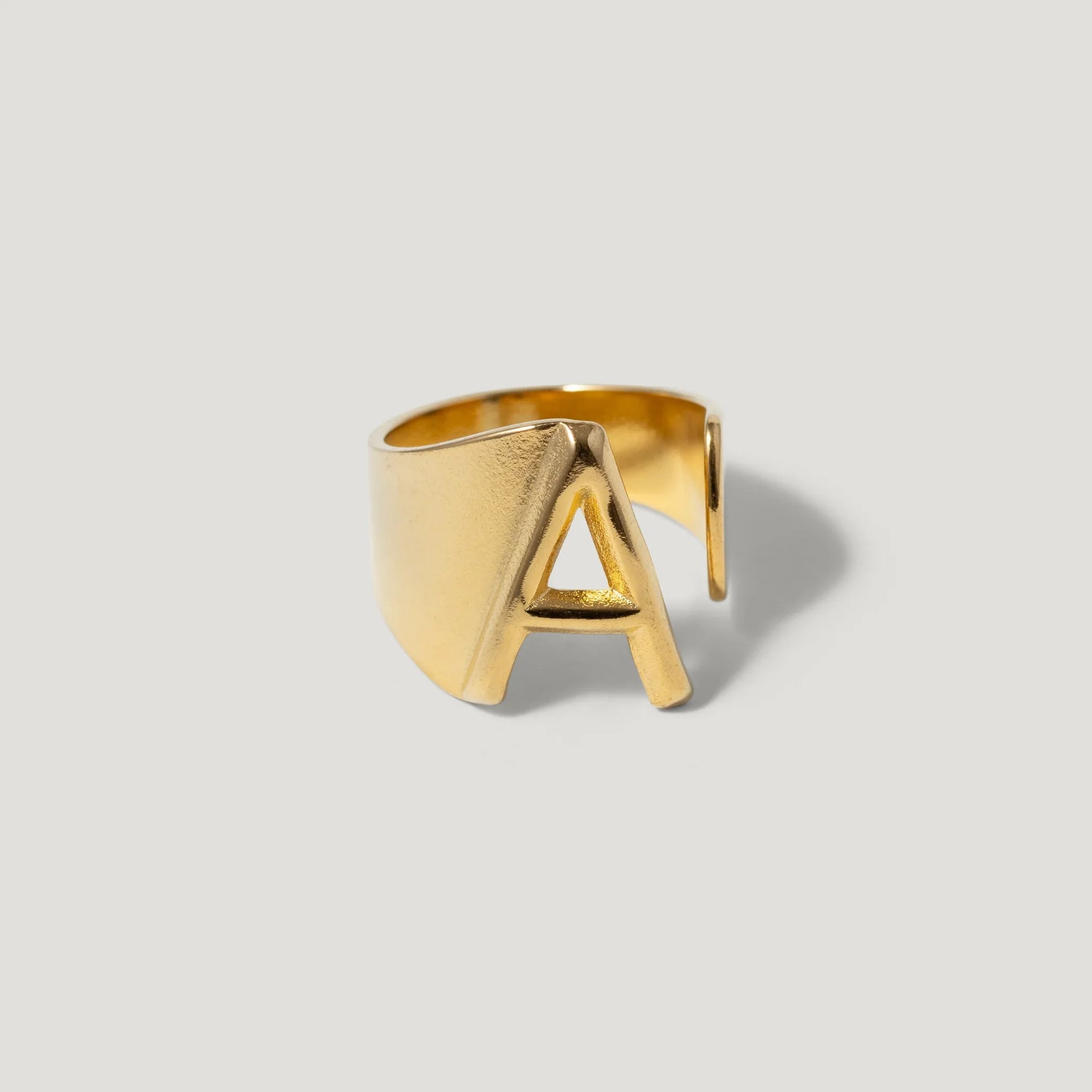 Gold adjustable ring with bold letter A design on white background