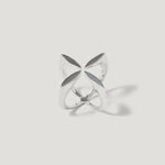 Modern silver ring with geometric, openwork petal design on white background