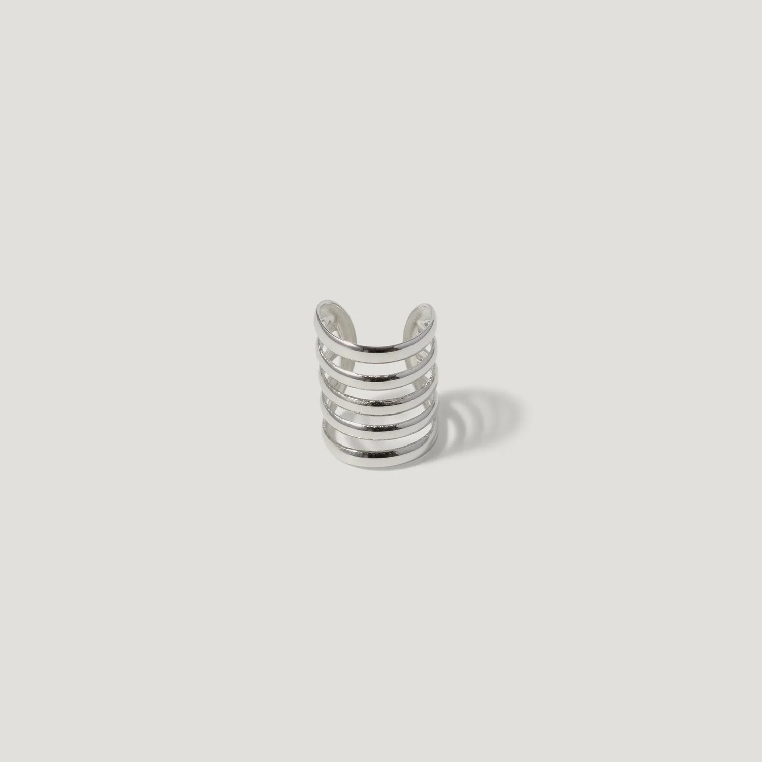 silver open cuff ring with five parallel bands on white background