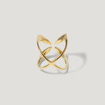Modern open gold ring with sculptural, intersecting bands on a light background