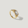 Gold ring with an oval clear gemstone set in a modern prong setting on white background.