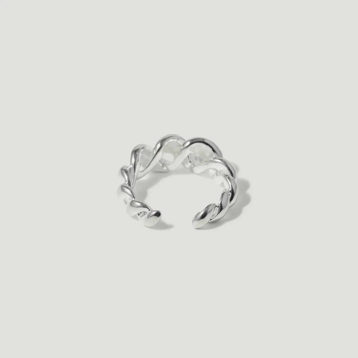 Sterling silver twisted open ring with polished finish on white background