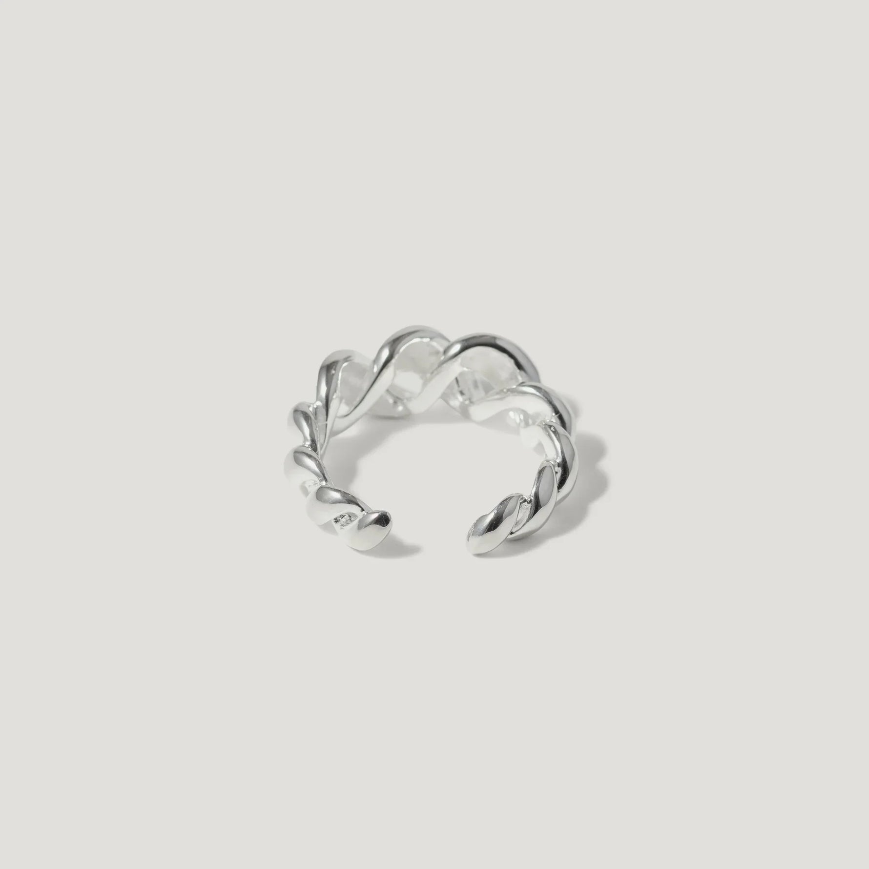 Sterling silver twisted open ring with polished finish on white background
