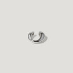 Minimalist silver ear cuff with smooth polished finish on white background