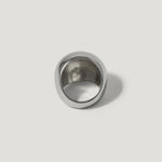 Bold silver statement ring with a wide, smooth band on a white background