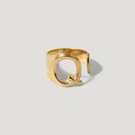 Gold adjustable ring with bold letter Q design on a light background