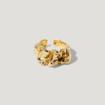 Gold textured open band ring with organic sculpted design on light background