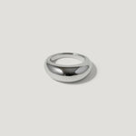 Polished silver dome ring on white background, minimalist jewelry design