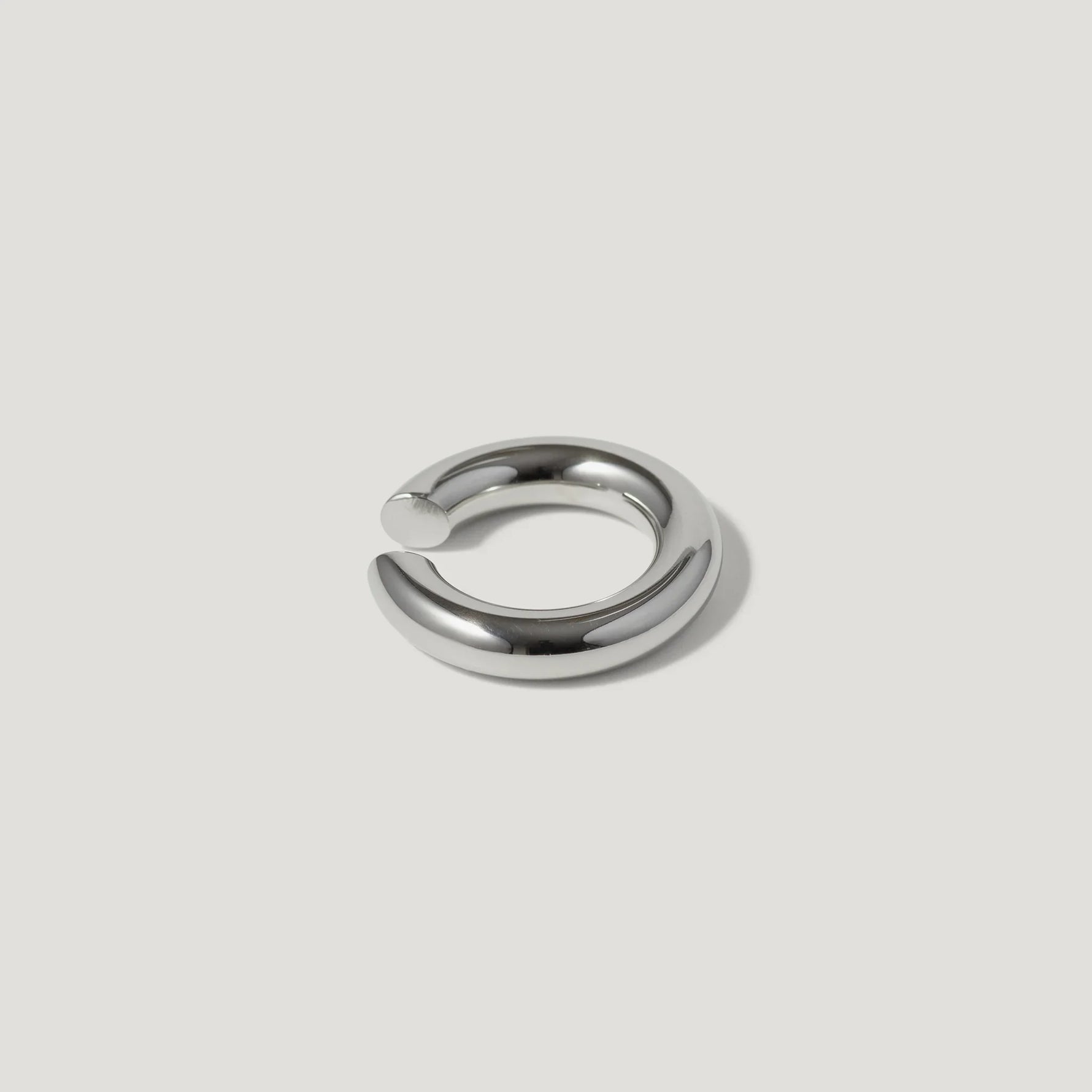 Minimalist silver chunky open ring on a white background