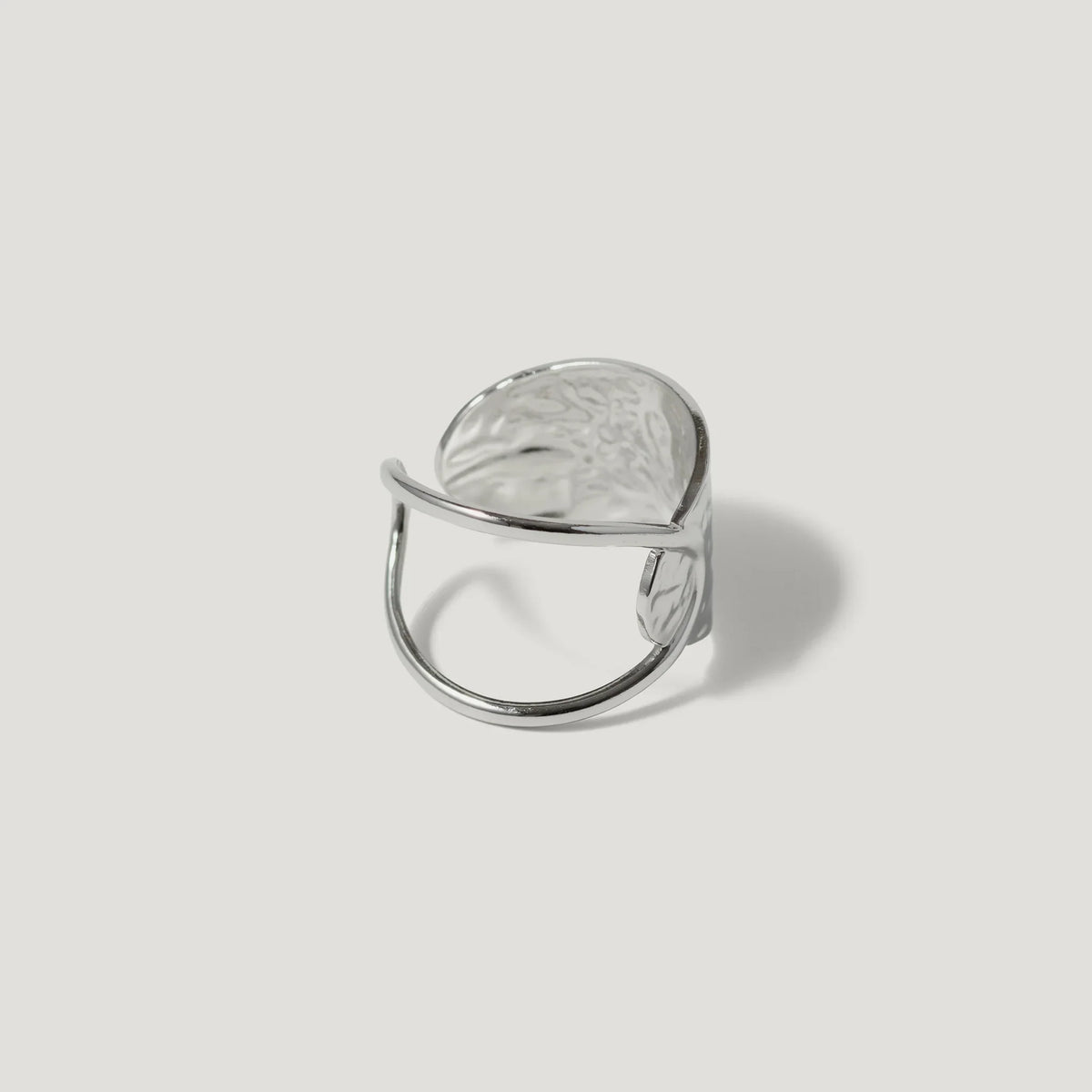 Contemporary silver statement ring with an open adjustable band and textured finish