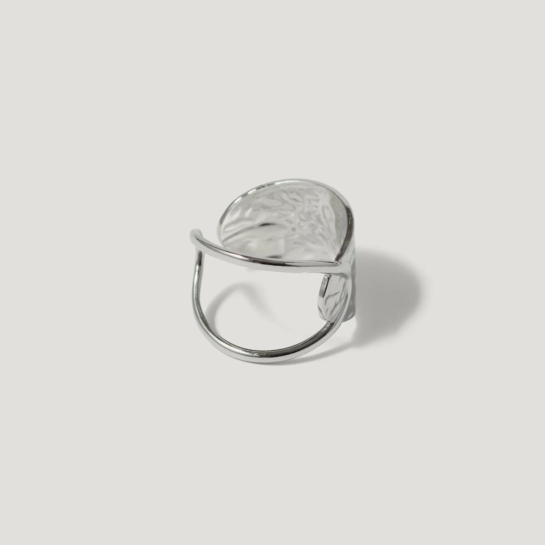 Contemporary silver statement ring with an open adjustable band and textured finish