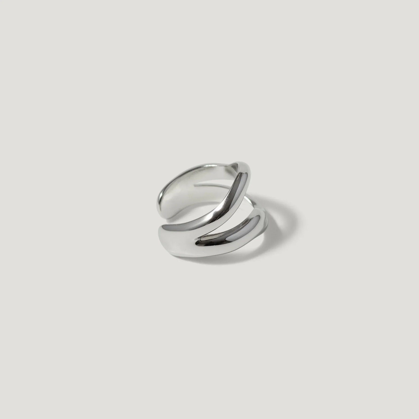 Minimalist open silver ring with a modern double band design on a light background