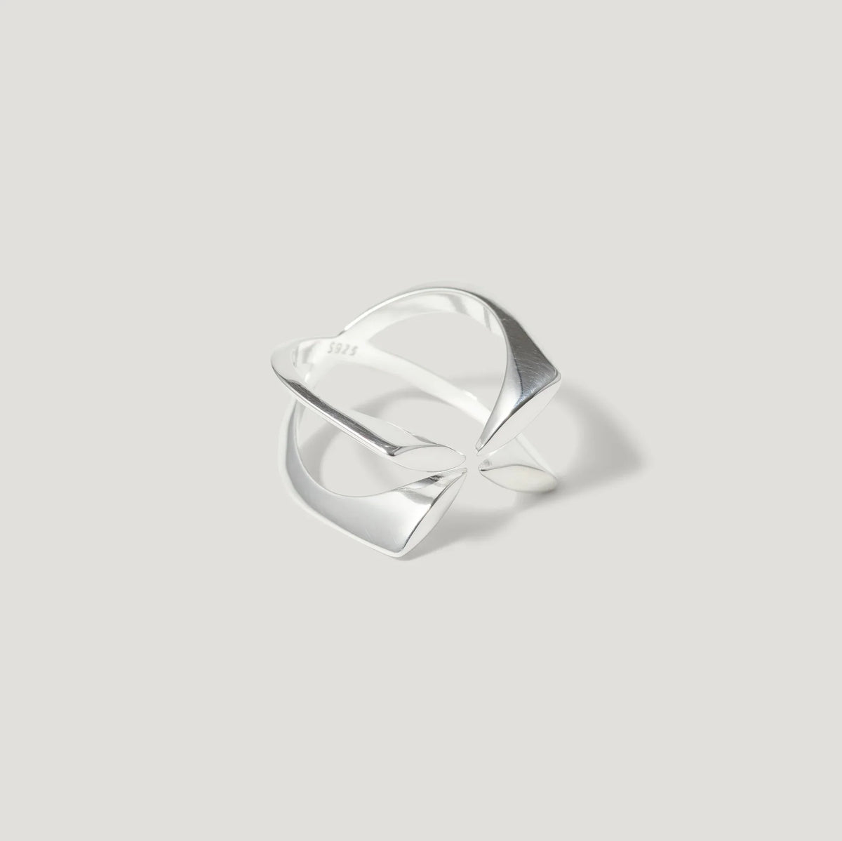Modern geometric sterling silver ring with open design on light background