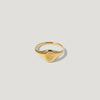 Gold signet ring with engraved floral design on plain white background
