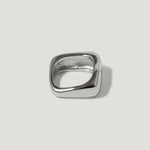Modern square silver ring with polished finish on plain background