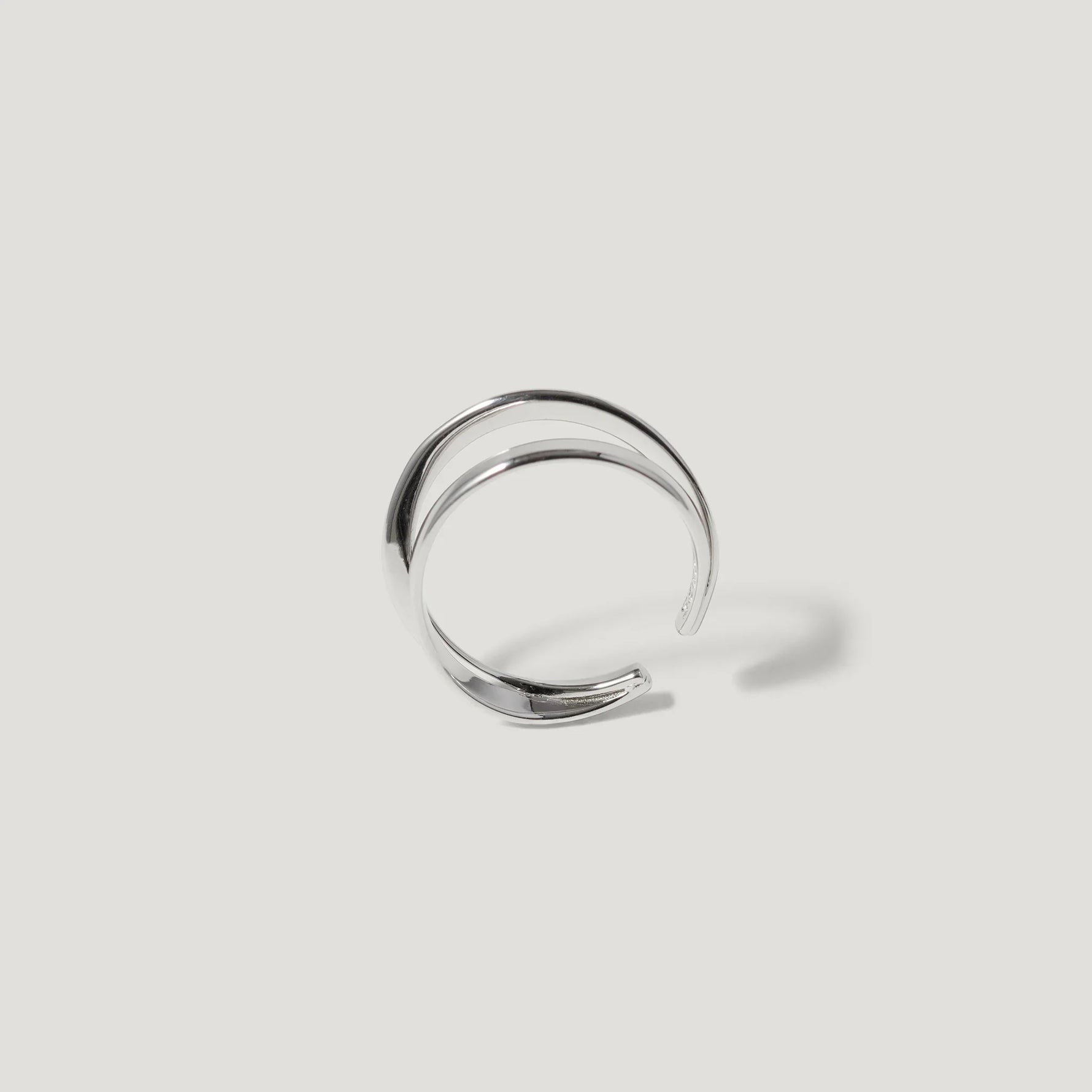 Minimalist silver open cuff ring on white background, modern jewellery design