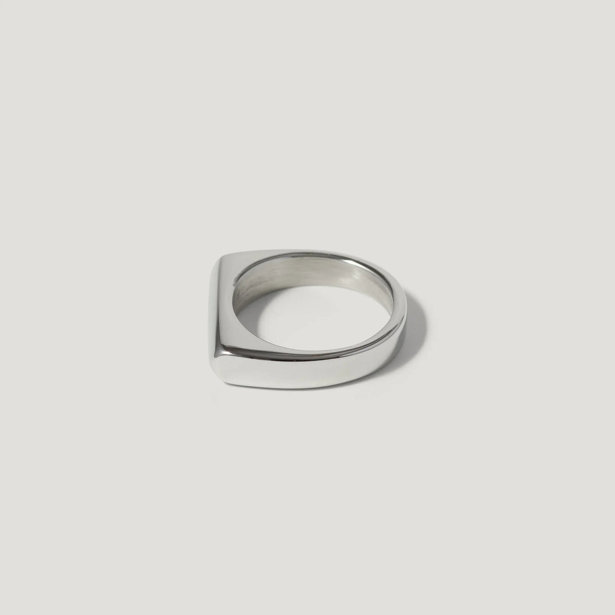 Square top silver ring with minimalist design on white background