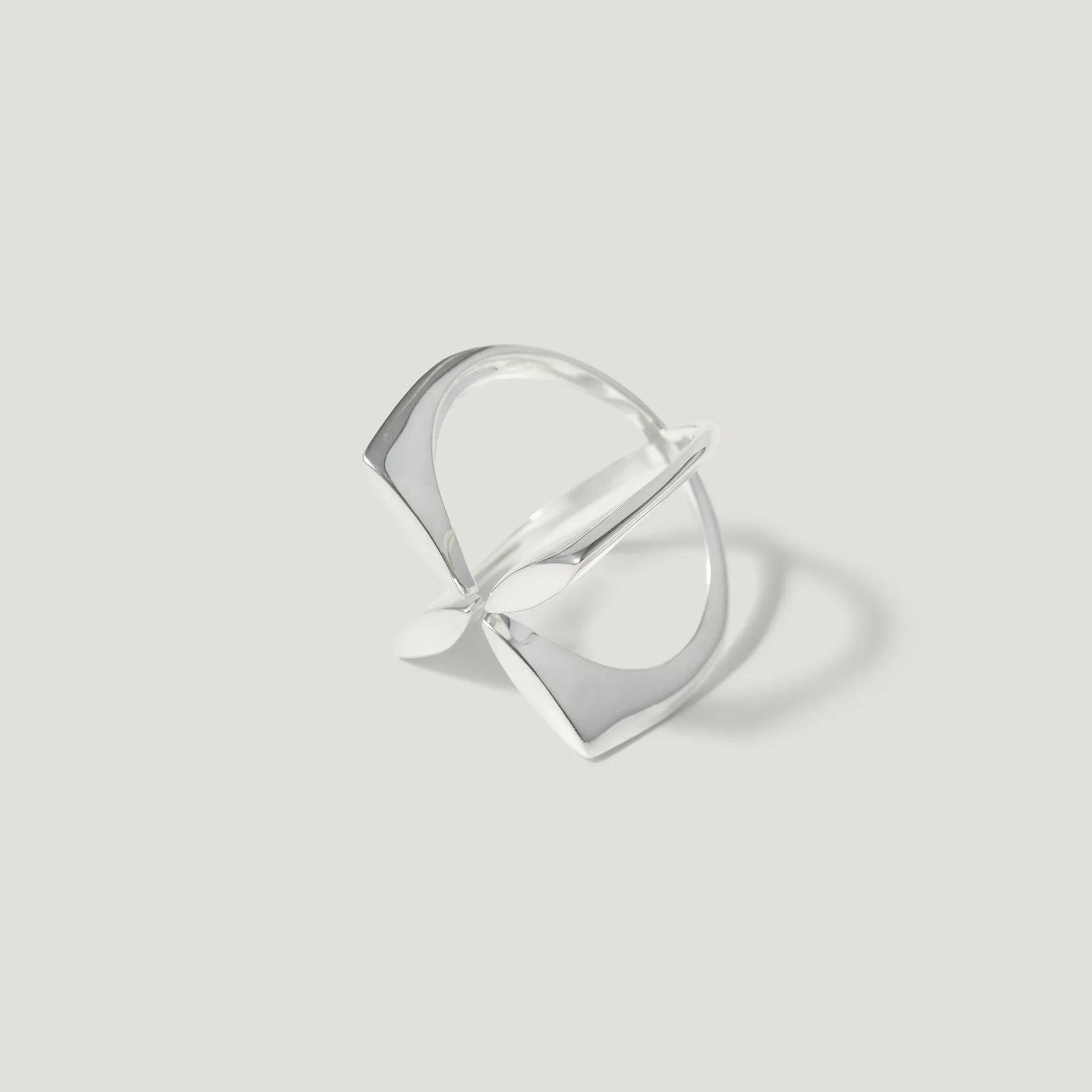 Modern geometric silver ring with open square design on light background